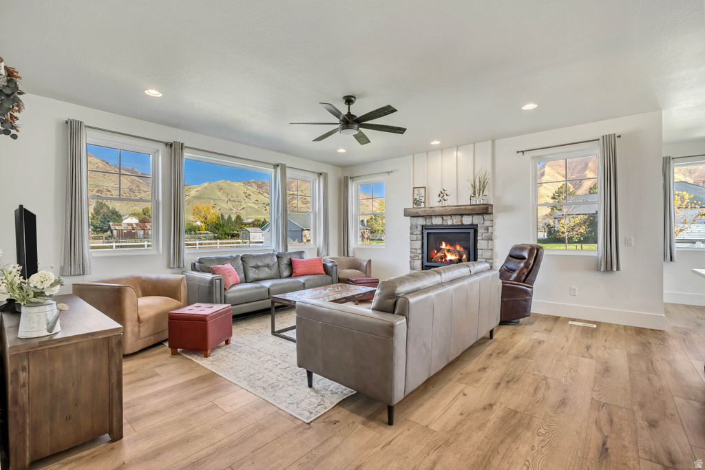 Spacious living area featuring wood-finish flooring, recessed lighting, and a ceiling fan