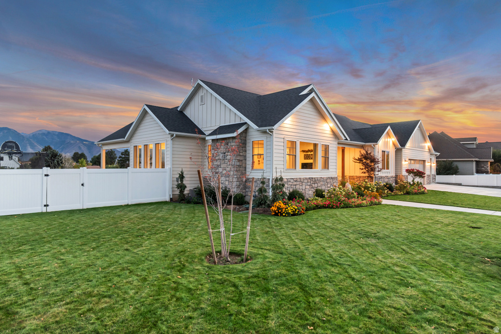 Ranch-style residence featuring light-colored siding and stone accents