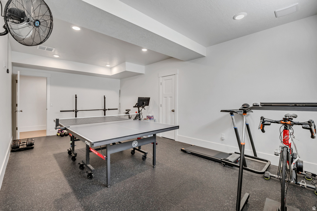 Spacious interior room featuring durable dark rubberized flooring and bright recessed lighting