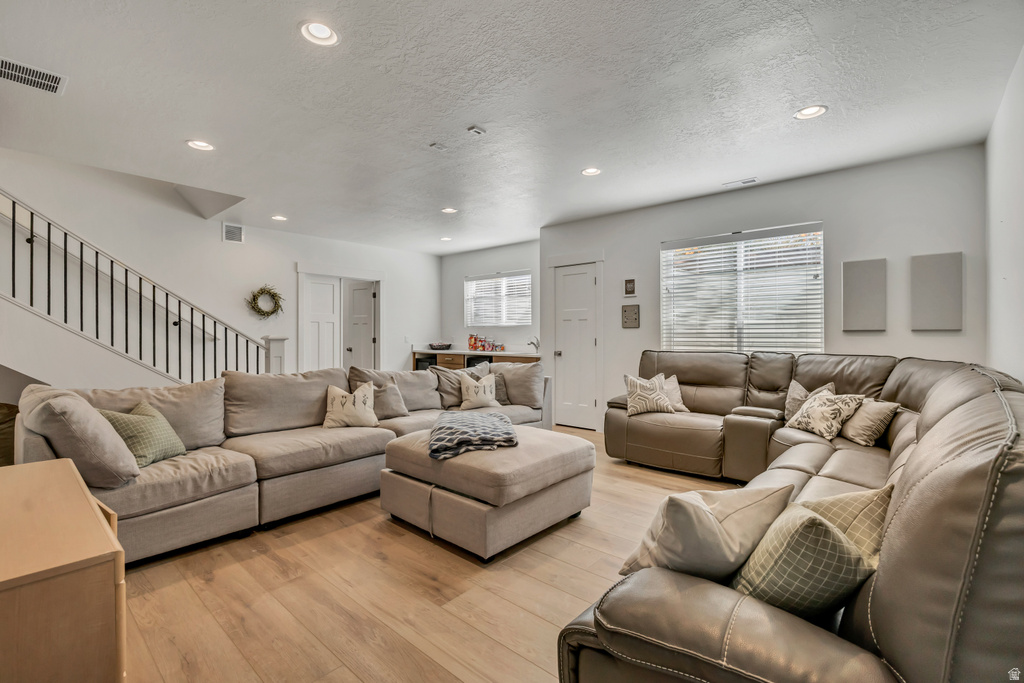 Spacious interior featuring light wood-finish flooring, recessed lighting, and white walls