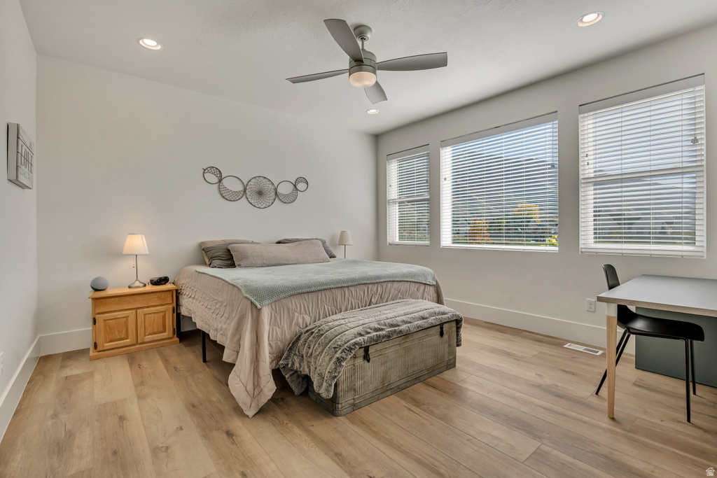 Bedroom featuring light wood-finish flooring, recessed lighting, and a ceiling fan