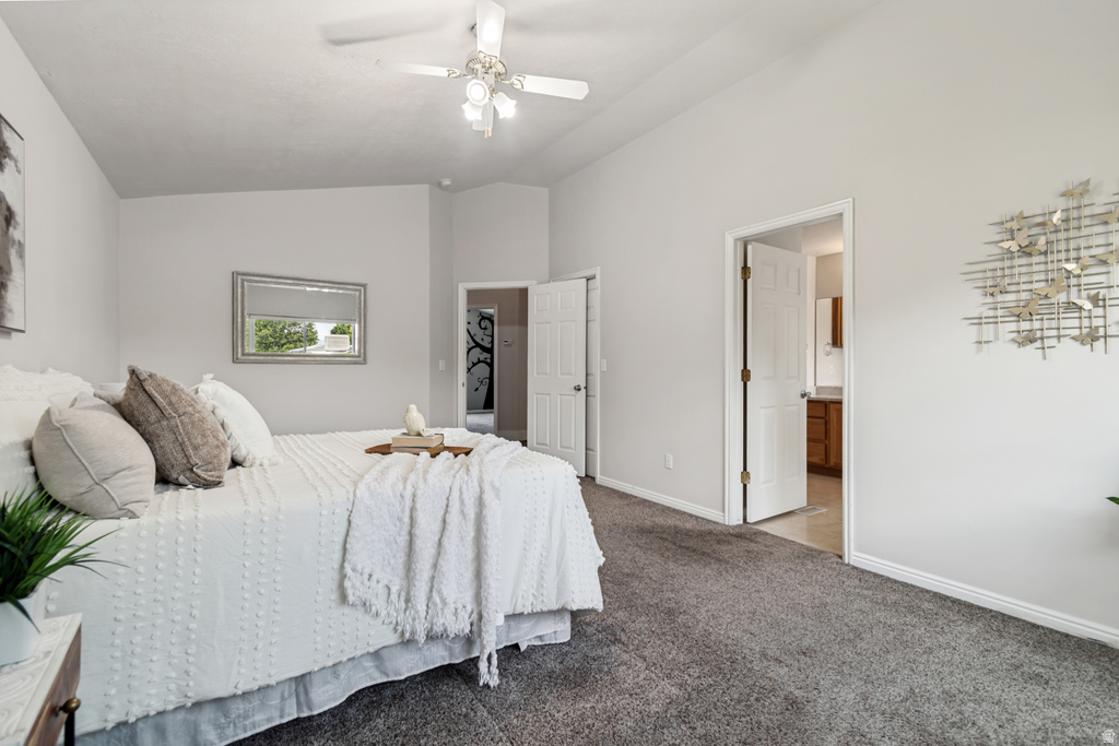 Spacious room featuring vaulted ceilings, a ceiling fan with integrated lighting, and plush grey carpeting
