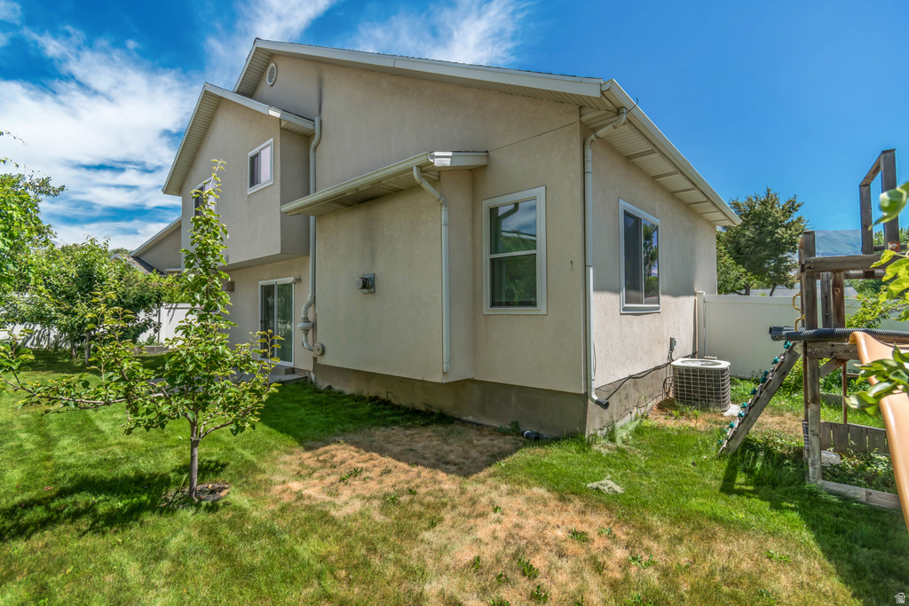 Rear exterior with stucco siding and multiple windows