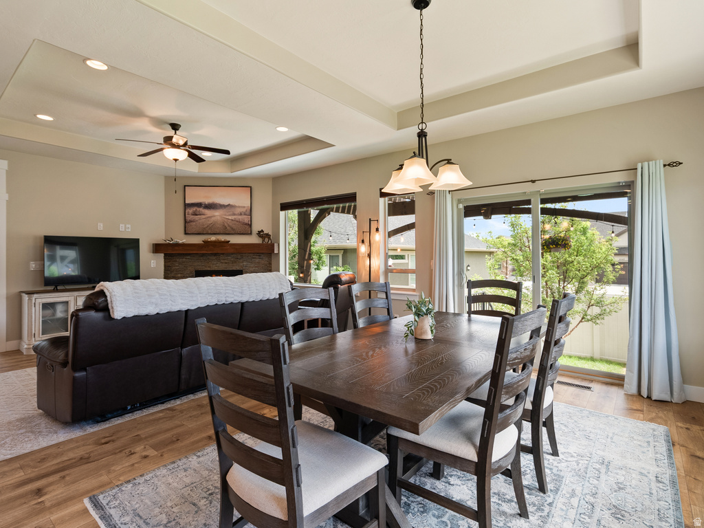 Dining area with wood-finish flooring and a tray ceiling