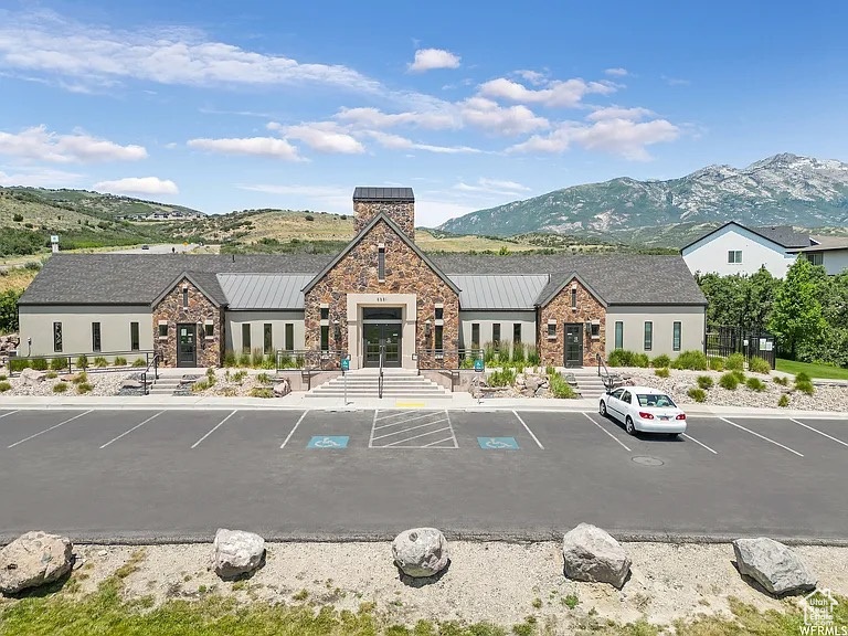 Stone and stucco facade building featuring a central tower element
