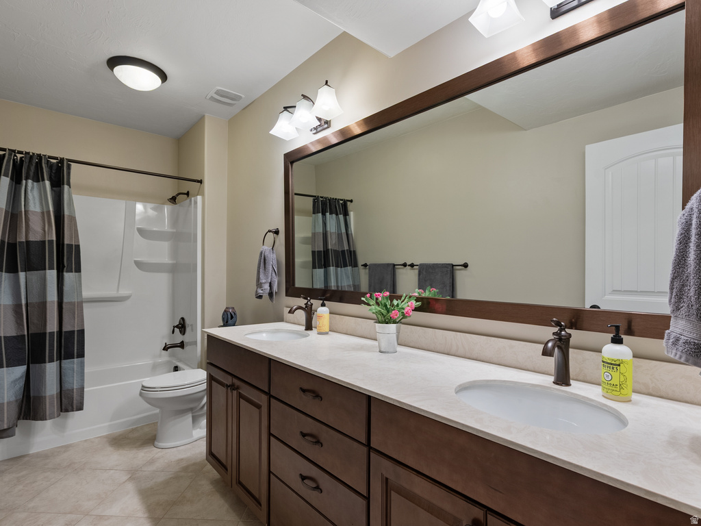 Double vanity featuring dark wood cabinetry, integrated sinks, and bronze-finish fixtures
