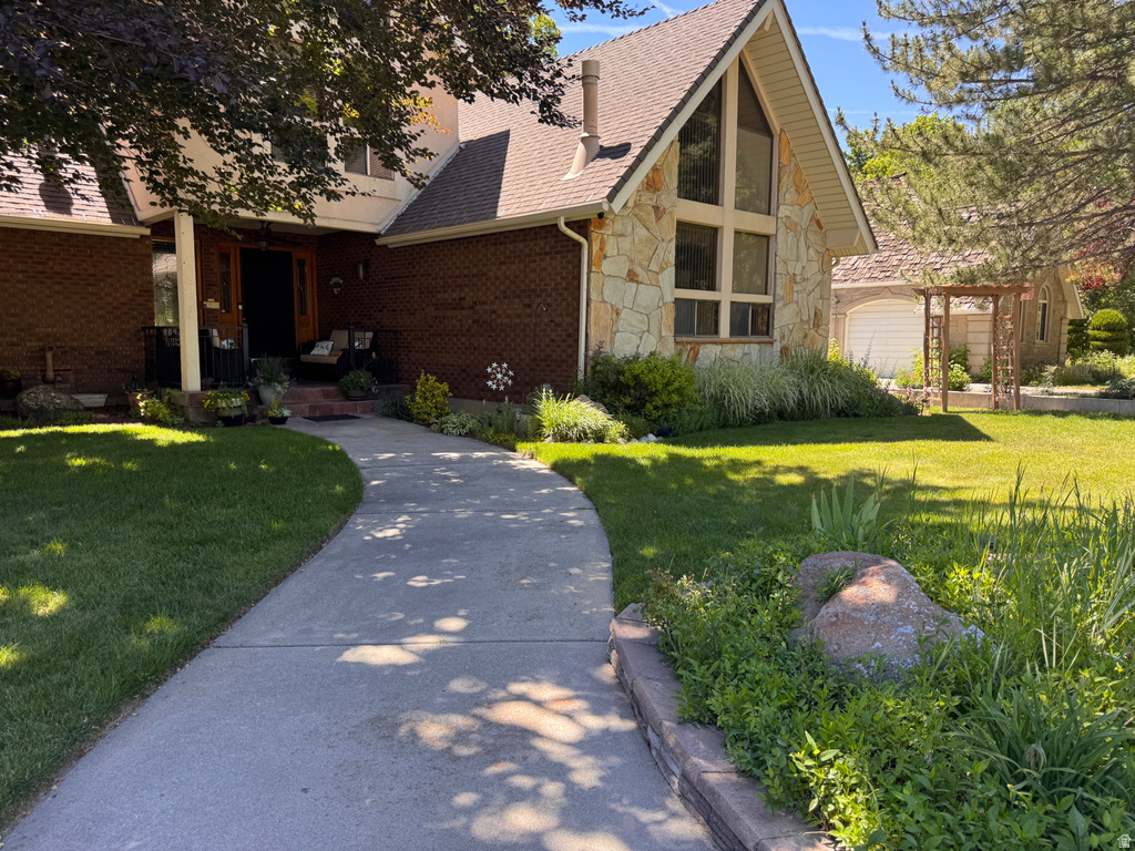 Brick and stone-clad exterior with an A-frame architectural feature and large picture windows