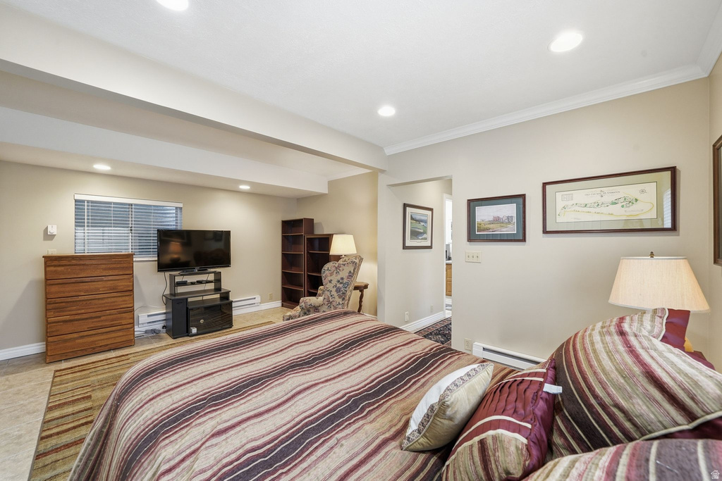 Recessed lighting illuminates this room, featuring light-colored walls, crown molding, and a window with blinds