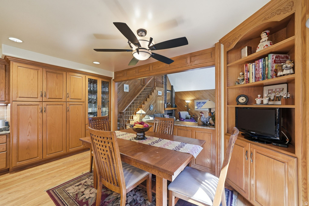 Dining area featuring built-in cabinetry, wood-finish flooring, recessed lighting, and a ceiling fan