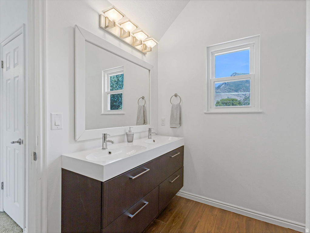 Dual vanity with a wood-finish cabinet, contemporary white countertop, and brushed nickel hardware