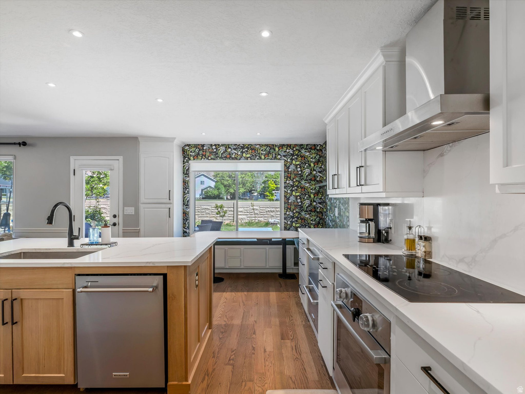 Modern kitchen featuring white cabinetry, stainless steel appliances, and light-toned countertops