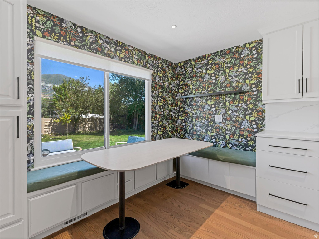 Built-in banquette seating with storage featuring green cushions