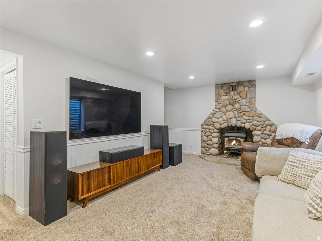 Living space featuring a stone-clad fireplace and wood-burning stove
