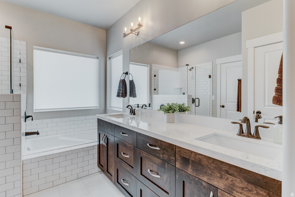 Double vanity featuring wood-finish cabinetry, white countertops, and bronze-finish fixtures