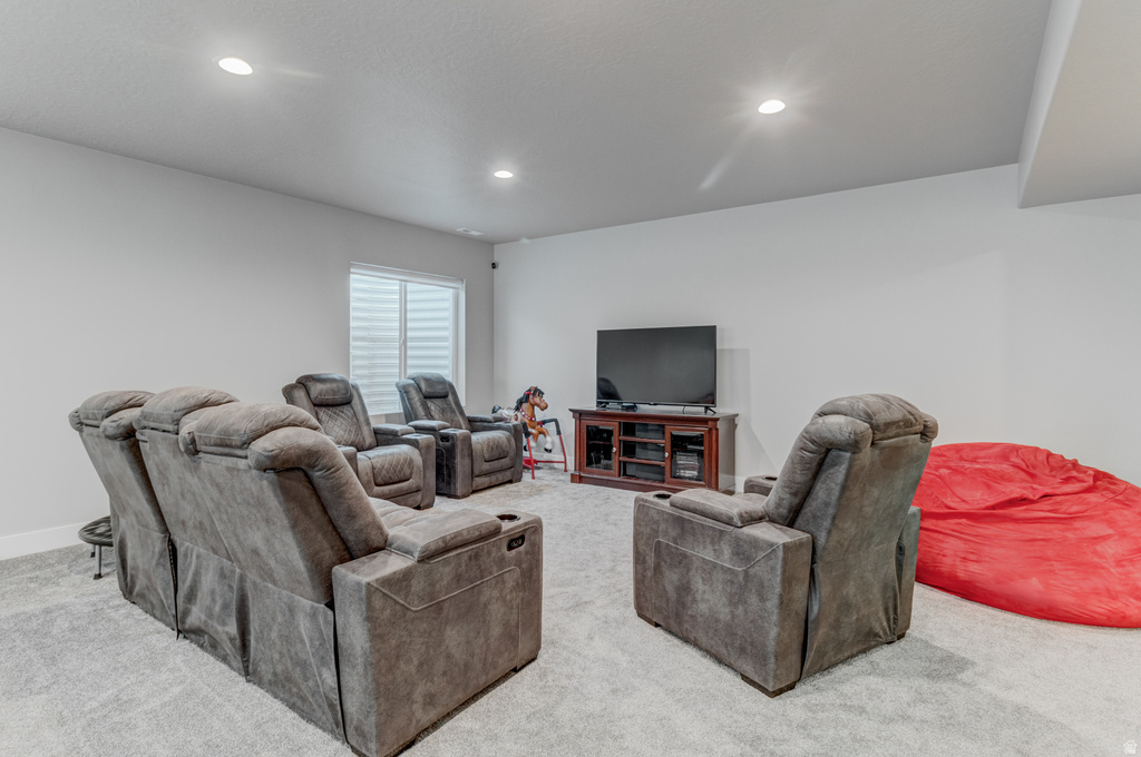 Recreation room featuring plush carpet flooring, recessed lighting, white walls, and a window with horizontal blinds