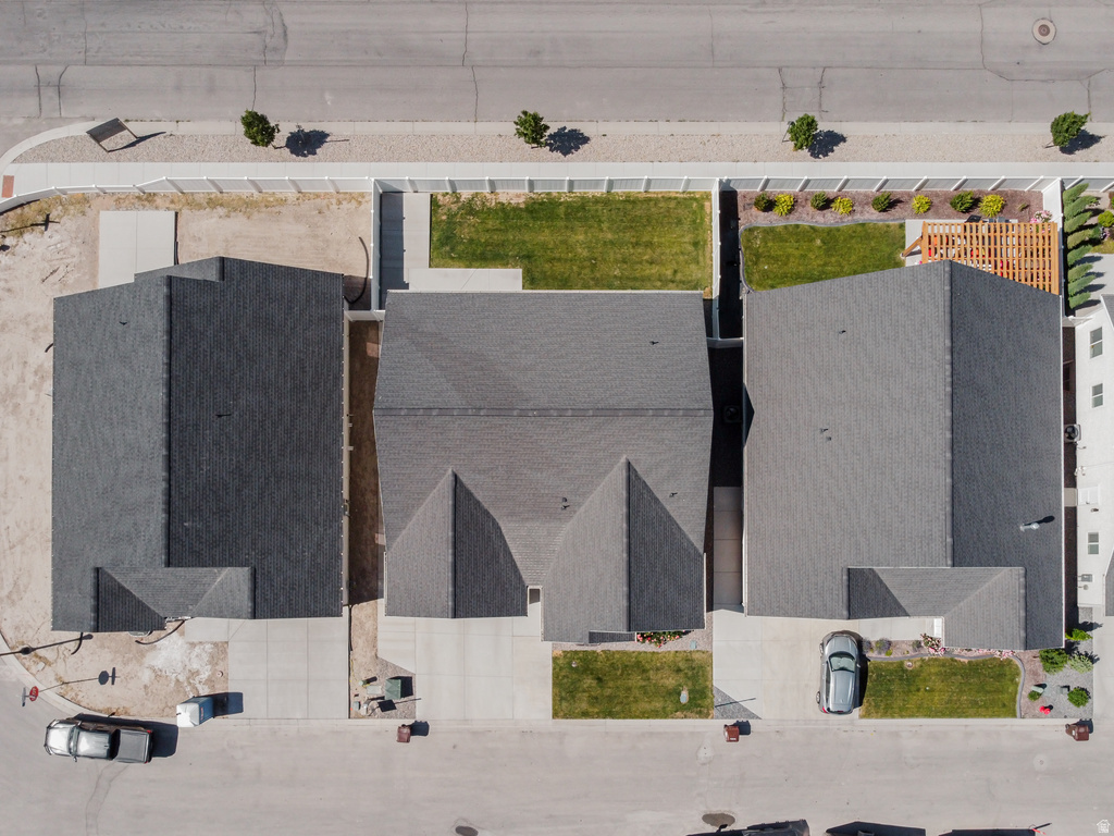 Aerial perspective showcasing three properties with dark gray shingle roofing and concrete driveways