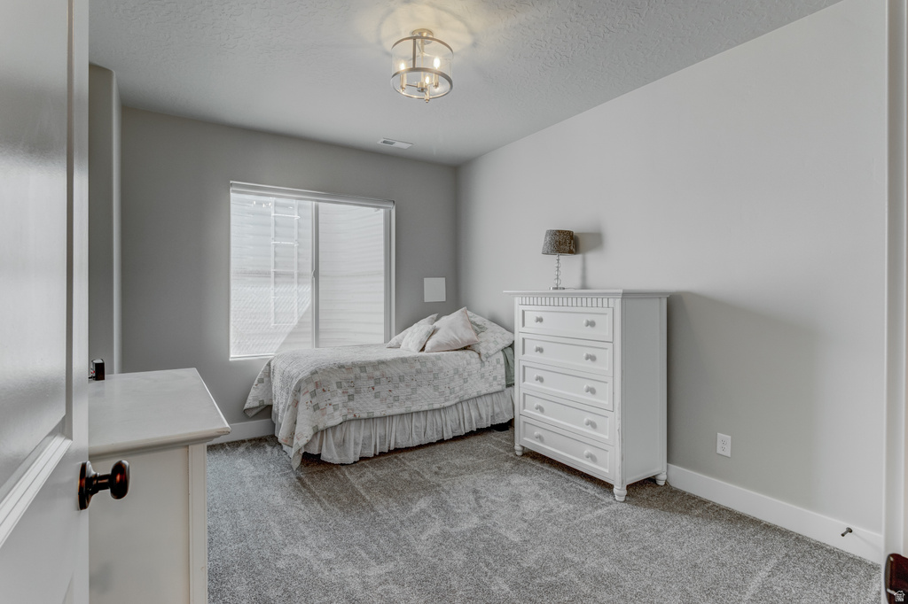 Carpeted interior room with neutral gray walls and white trim