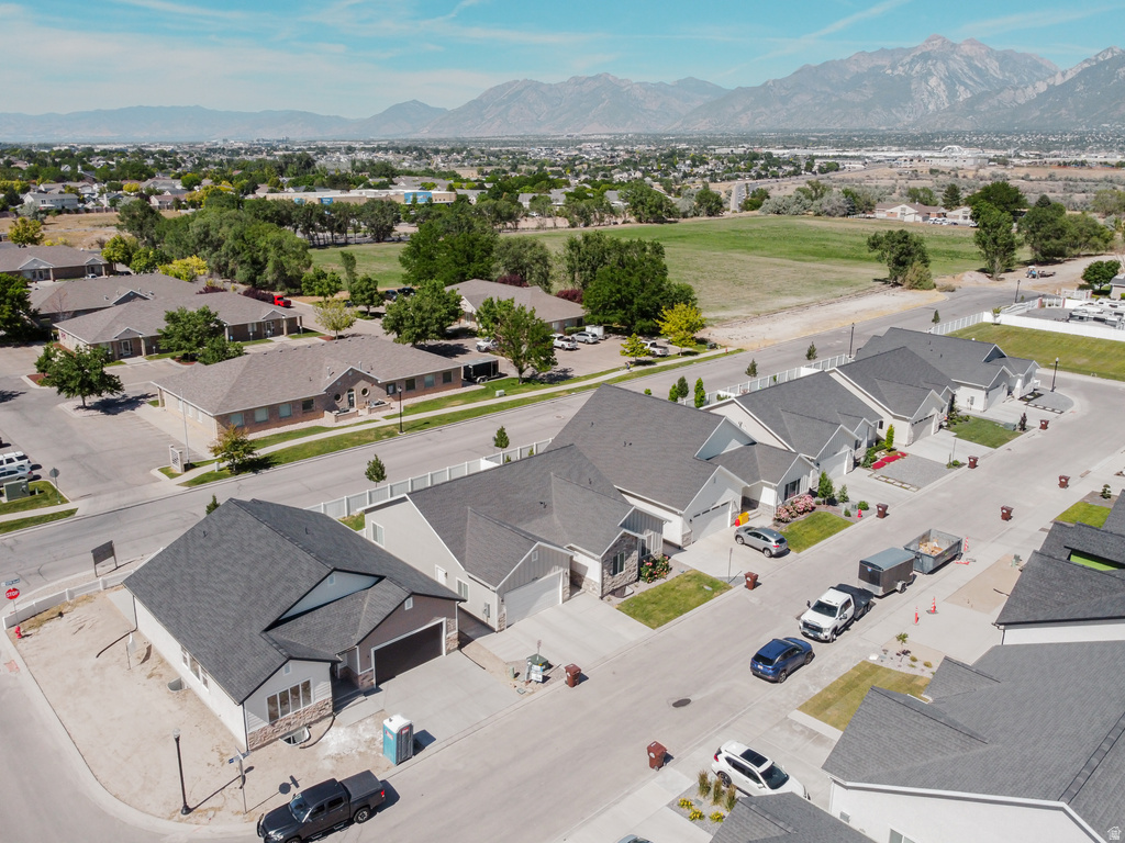 Residential neighborhood featuring single-family homes with dark shingle roofs and varied siding materials