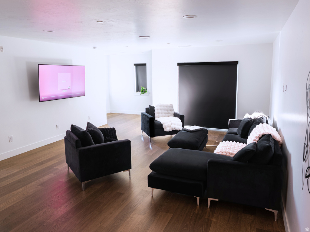 Spacious living area featuring wood-finish flooring and recessed lighting