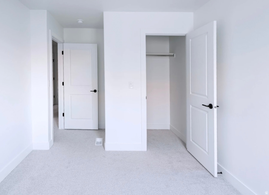 Neutral-toned wall-to-wall carpeting throughout this interior space