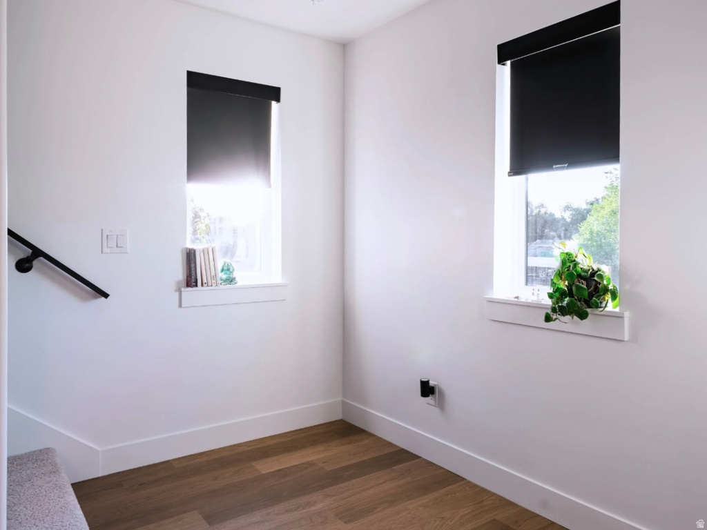Bright space featuring wood-finish flooring and white baseboards