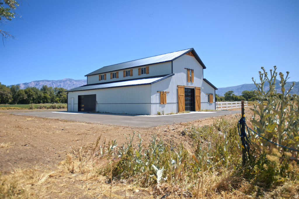 Two-story barn structure with corrugated metal siding and a dark metal roof