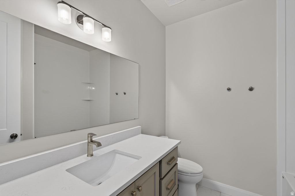 Bathroom vanity featuring an integrated rectangular sink, brushed nickel faucet, and white countertop