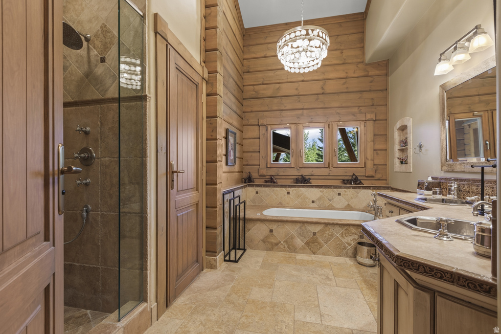 Expansive bathroom featuring a glass-enclosed shower, a large soaking tub, and a double vanity with stone countertops