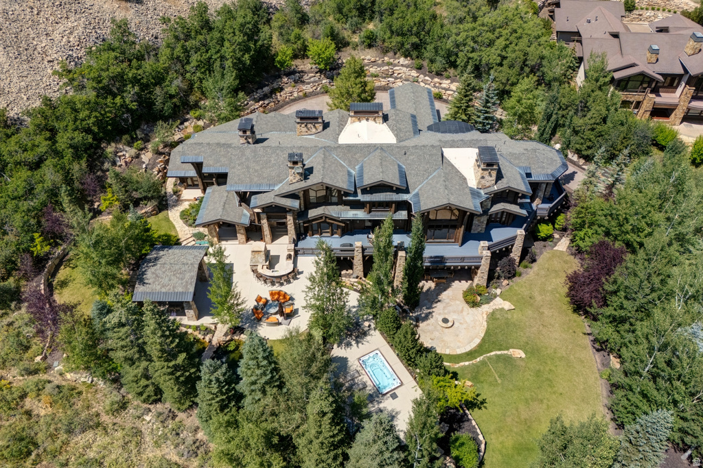 Expansive multi-level residence featuring a stone and wood exterior