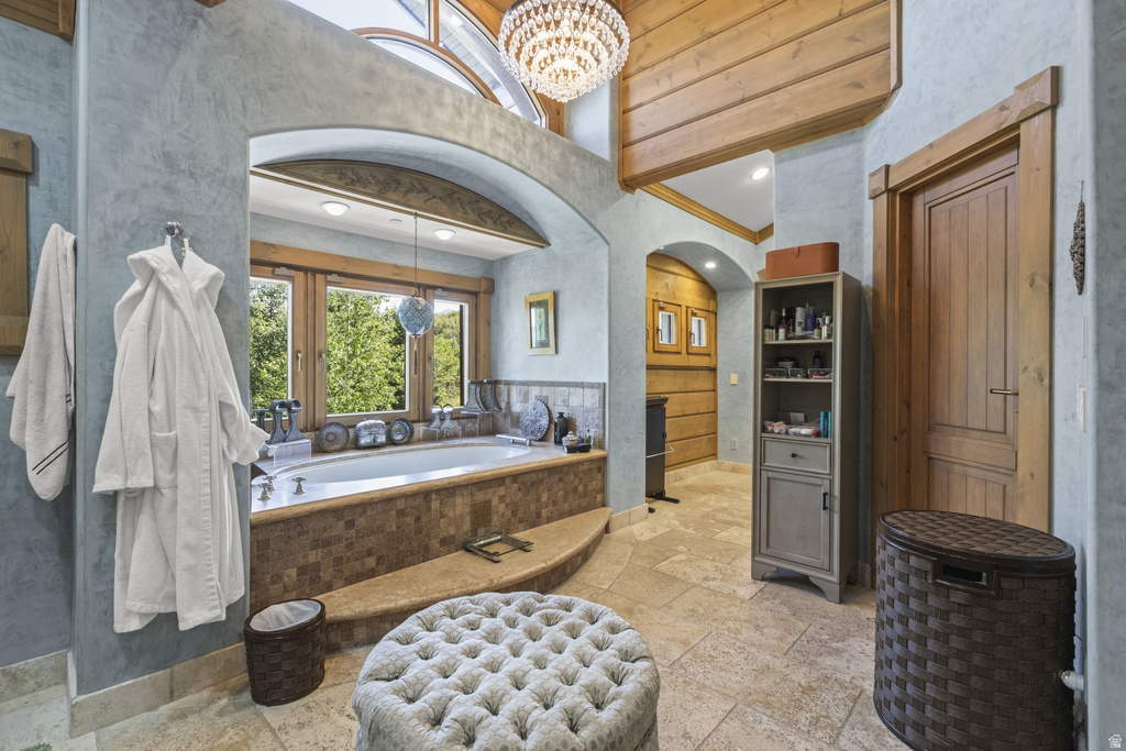 Soaking tub with mosaic tile surround and expansive window