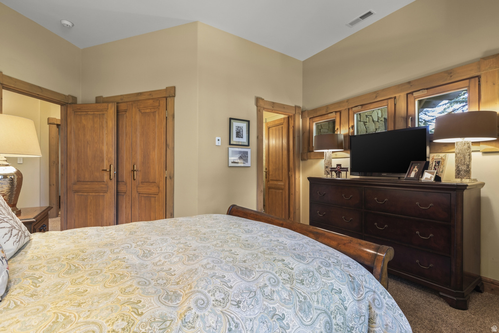 Bedroom featuring warm neutral wall tones and wood-finish trim