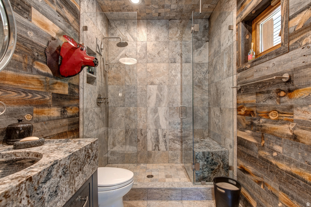 Spacious walk-in shower featuring a glass enclosure, built-in bench, and rain showerhead