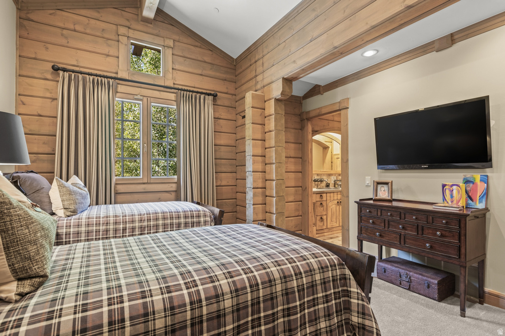Room featuring extensive wood-paneled walls and a vaulted ceiling with exposed beams