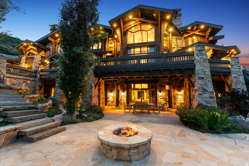 Multi-level architectural design featuring prominent stone and timber construction