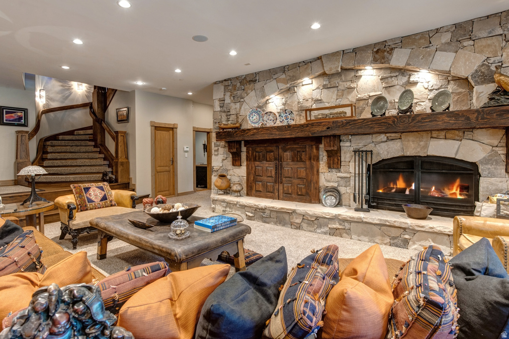Stone fireplace with a carved wood mantel, gas insert, and stone hearth