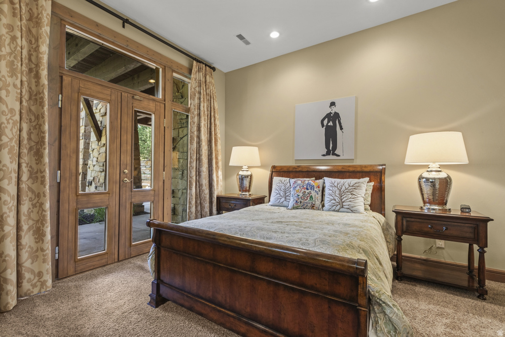 Double wood-finish doors with glass panels and transom windows