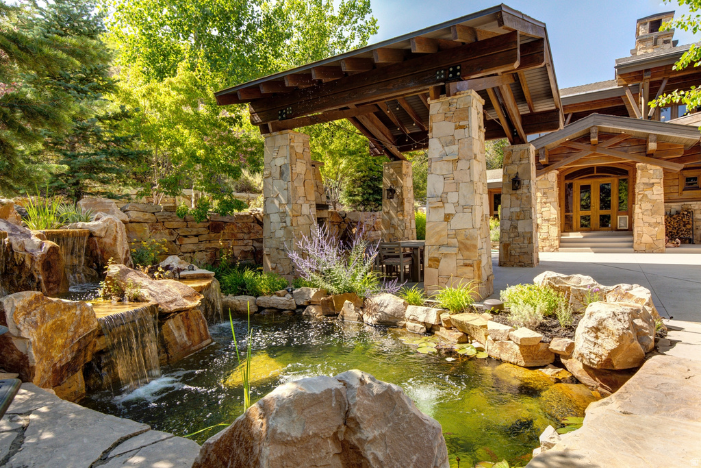 Stone waterfall and pond feature surrounded by natural landscaping