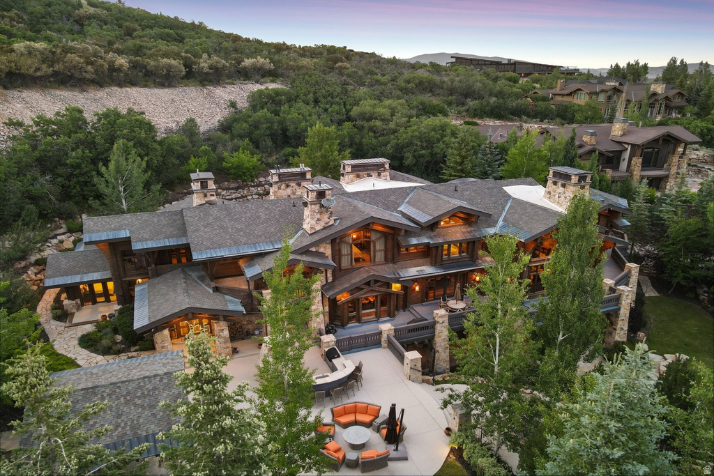 Expansive mountain retreat featuring multiple stone chimneys and a multi-level design