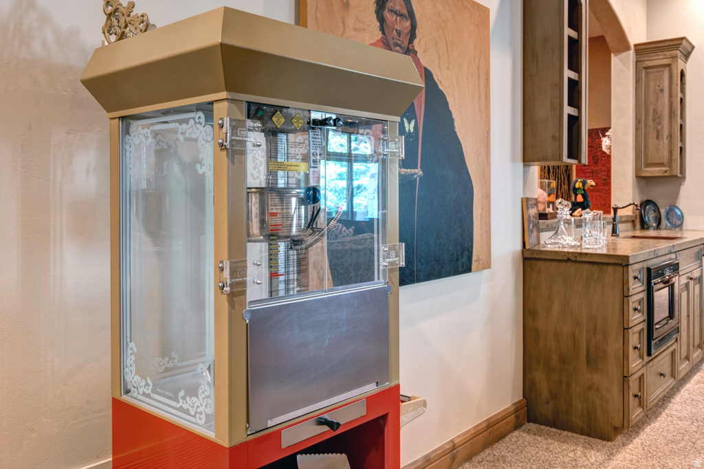 Built-in beverage station featuring custom cabinetry, integrated countertop, and an undercounter appliance