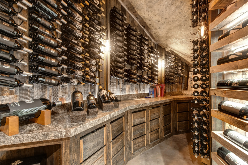 Custom wine cellar featuring extensive wall-mounted and built-in bottle storage