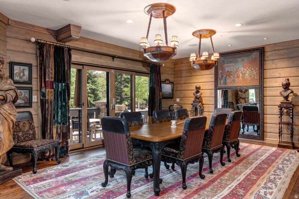 Dining area featuring wood-paneled walls and matching wood-finish flooring