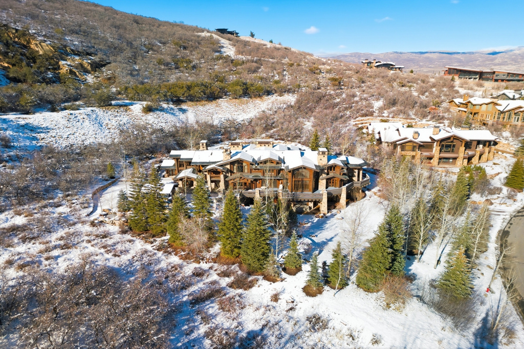 Expansive mountain property featuring a multi-level residence with extensive natural wood and stone detailing