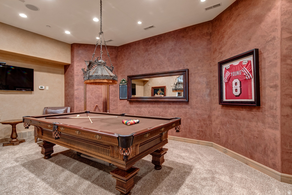 Recreation room featuring an ornate billiards table with a detailed wood frame, upholstered felt playing surface, and integrated ball pockets