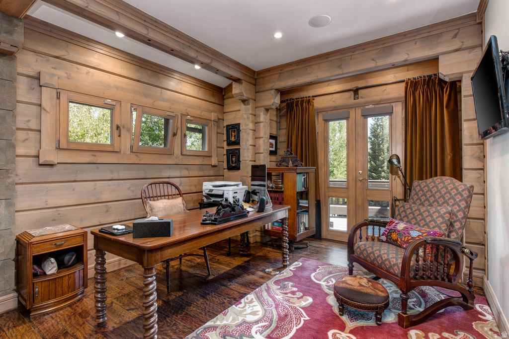 Wood-paneled room featuring three transom windows and a double glass-panel door