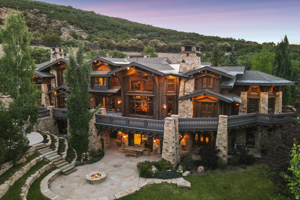 Multi-level mountain-style residence featuring extensive stone and wood cladding