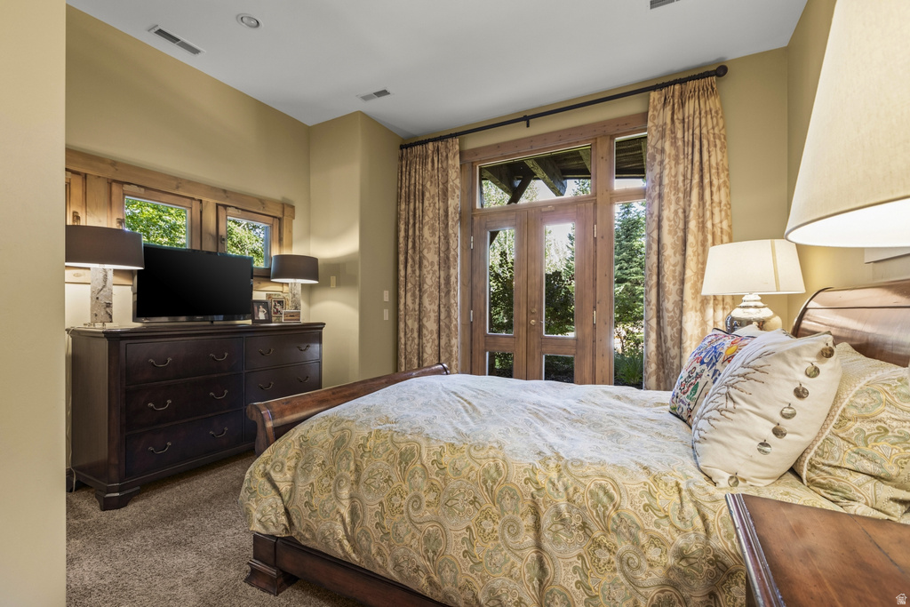 Room featuring wood-frame double doors with integrated glass panels, recessed lighting, and a neutral wall color