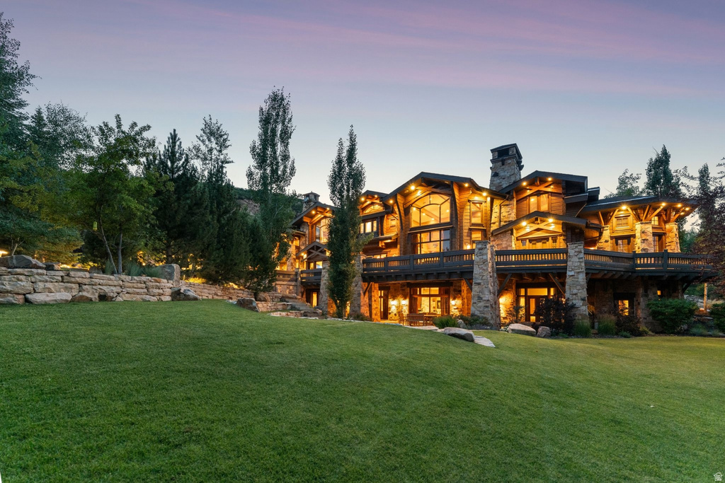 Expansive hillside property featuring a multi-story custom residence with stone and wood siding