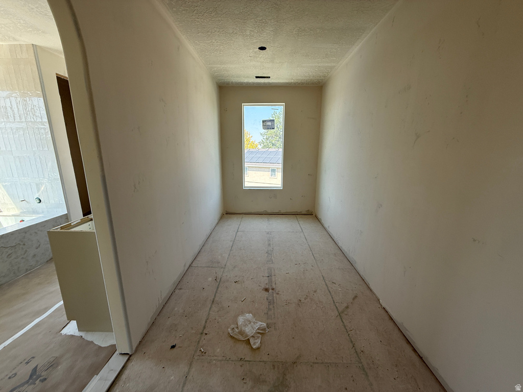 Hallway featuring a single window and recessed ceiling lights