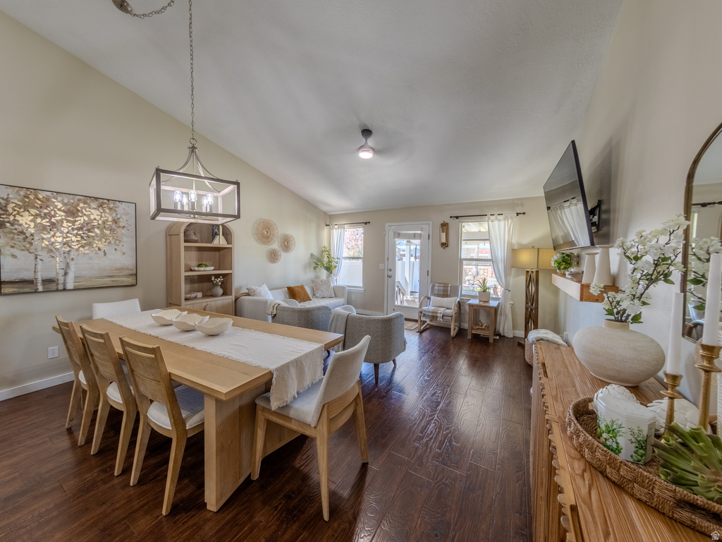 Vaulted ceilings above an open-concept living area with dark wood-finish flooring