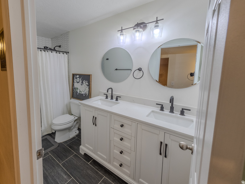 Dual vanity with white cabinetry and integrated sinks